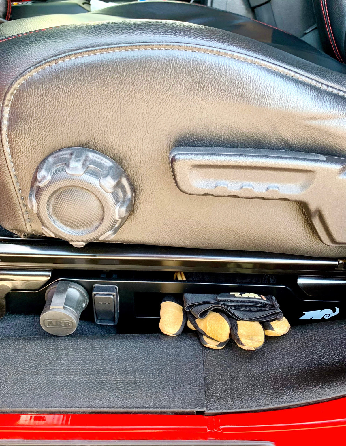 Car interior with black seat organizer below seat.