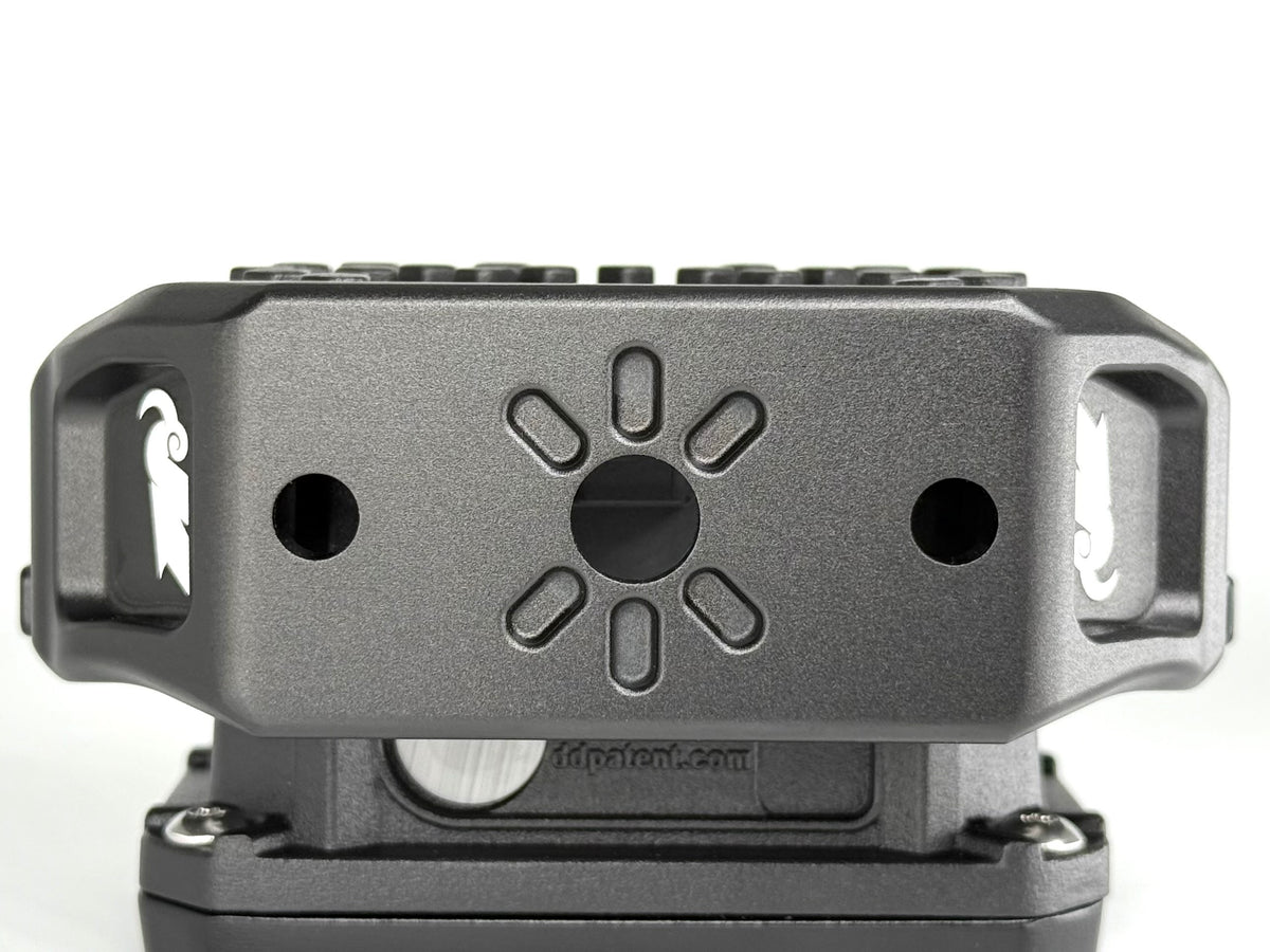 Close-up of a metallic mount with brand logo on a white background