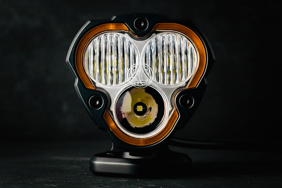 Close-up of a vintage-style headlight on a dark background