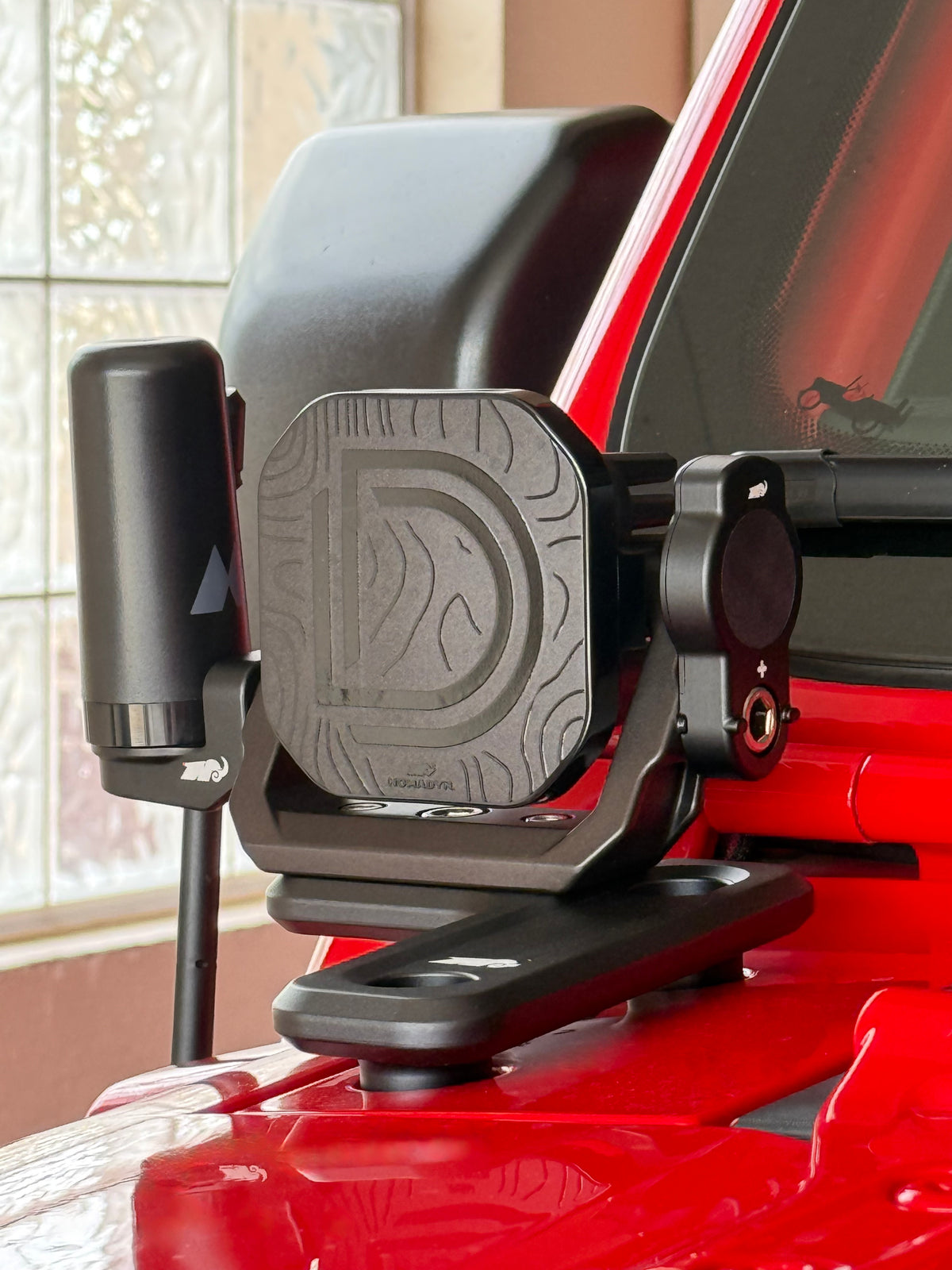 Off road light mount with antenna on red vehicle