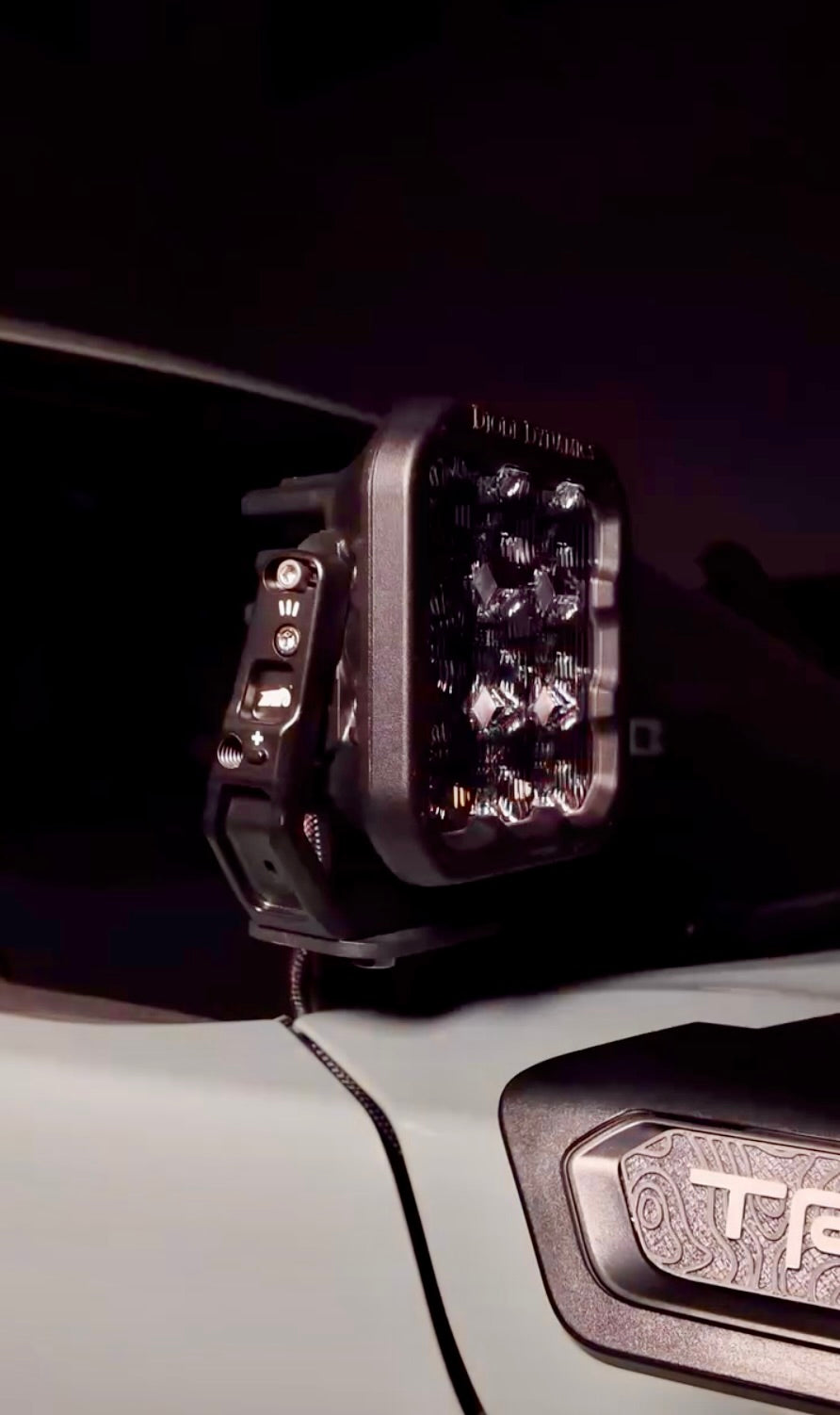 Close-up of a vehicle's off-road light on a dark background