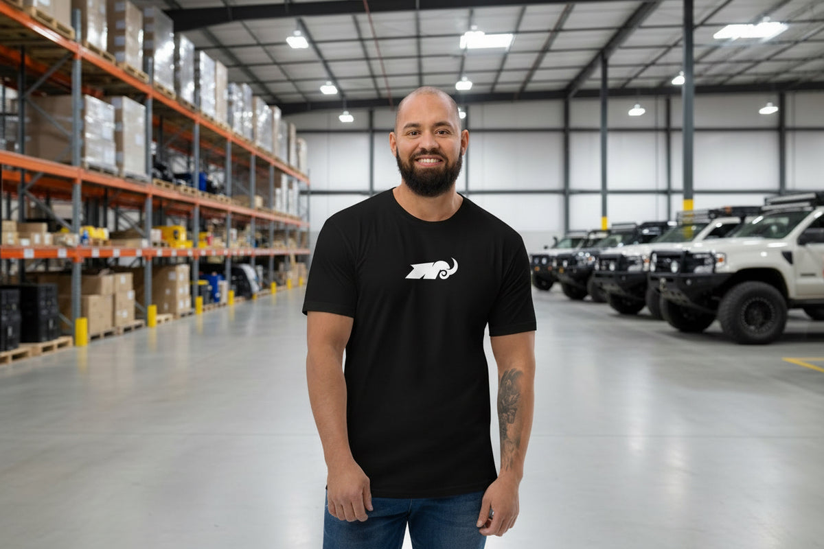 Man wearing a black t-shirt with a logo on a white background